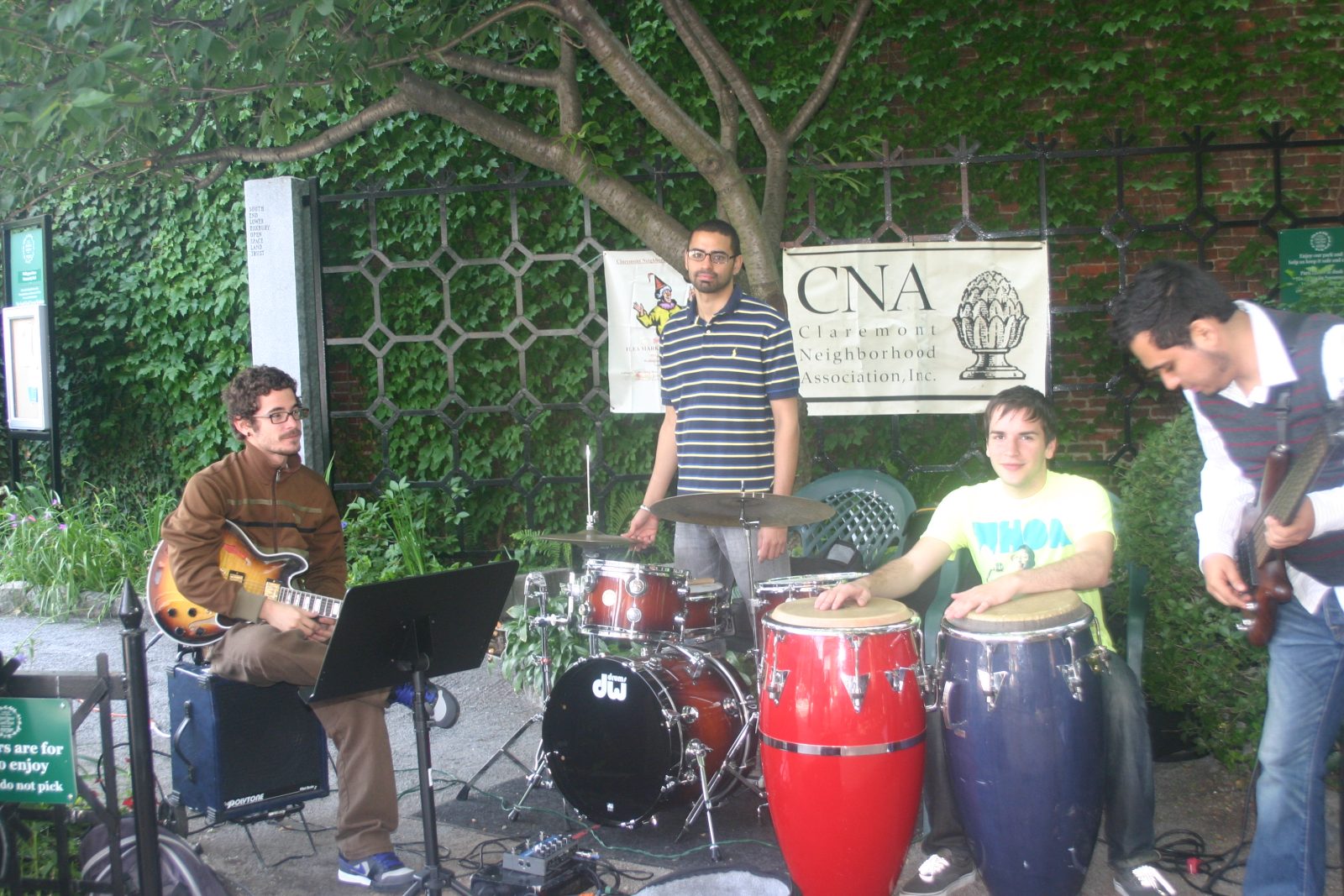 Full band performing outdoors at a jam session in the park