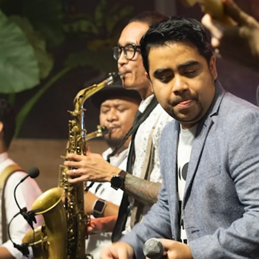 Young musicians perform energetically on saxophone and vocals.